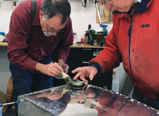 Rion Bourgeois (left) and Philip Groelz test the tank for leaks.