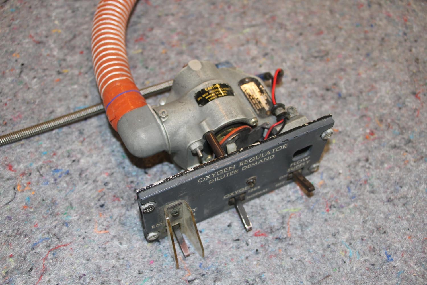 The little round flapper valve is opened or closed depending on if you want air mixed with O2, or pure (100%) O2 delivered to the mask. The air comes from the cabin environment, so take this into consideration in case of smoke.