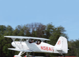 Old School Solution Starduster biplane over grass strip