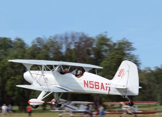 Old School Solution Starduster biplane over grass strip
