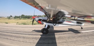 Taildragger aircraft at the point of transition from taxiing to flight.