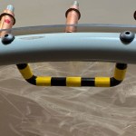Finished egress handle with striping, fastened in place with #8 screws.