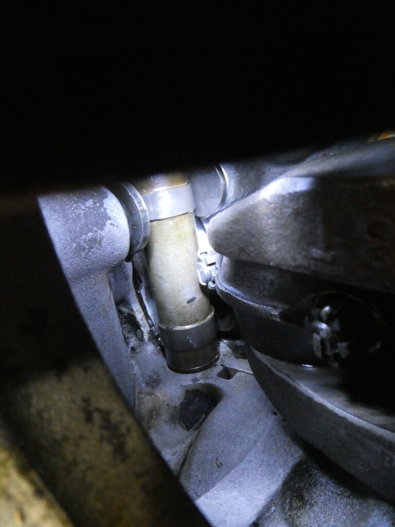 Permatex seen as the black stuff oozing out the part line, to the left of the cam shaft. Just no. Vintage, cottered rod bolt nuts also visible to the right.