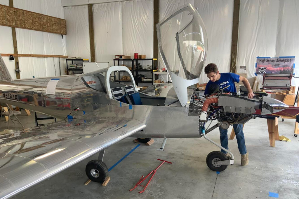 Student builder Kody Bocksch works on the ACES RV-12 as it nears completion. [Credit: North Idaho High School Aerospace Program]