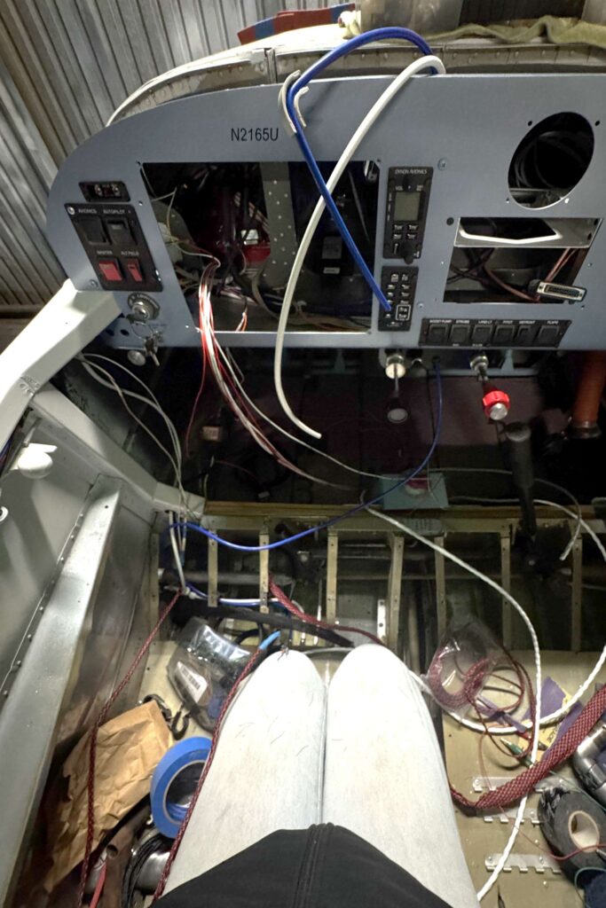 A rat’e nest of wires leading to nowhere, including navigation lights, control stick wires, autopilot wires, and coax cables.