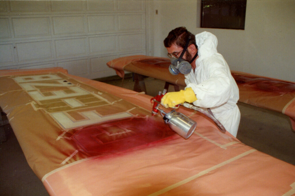 The author spraying the registration letters on his Stinson 108 wings. [Credit: Mike Davenport]