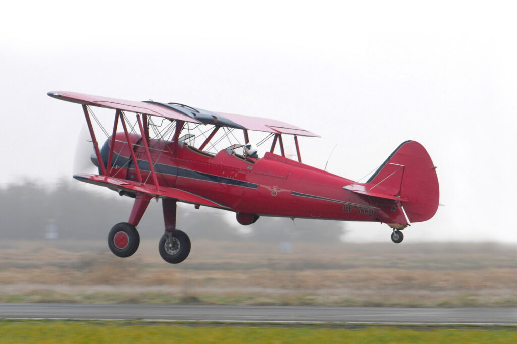 Boeing Stearman Model 75 serial number 003, now restored, departs for Oliver, BC, Canada.