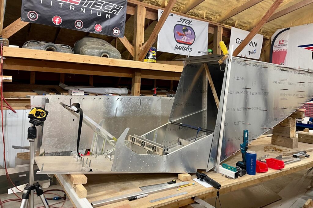 Lasers, levels, and the Super701/half fuselage on the build table.