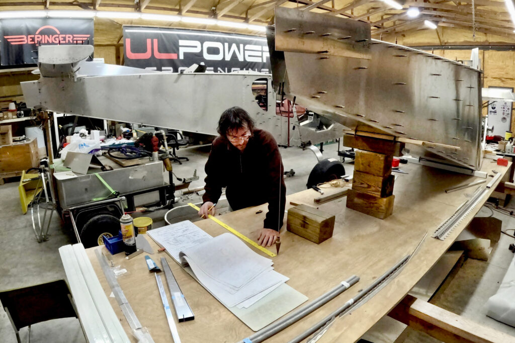 Jon measuring from the plumb bob to help line up the rear fuselage.
