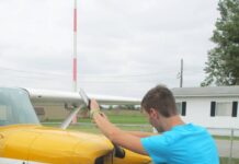 The alternative to bending down as the propeller is pulled through the compression stroke is to keep the back straight and bend the knees slightly, stepping away in a crouch. [Credit: LeRoy Cook]