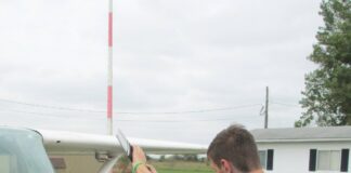 The alternative to bending down as the propeller is pulled through the compression stroke is to keep the back straight and bend the knees slightly, stepping away in a crouch. [Credit: LeRoy Cook]
