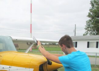 The alternative to bending down as the propeller is pulled through the compression stroke is to keep the back straight and bend the knees slightly, stepping away in a crouch. [Credit: LeRoy Cook]