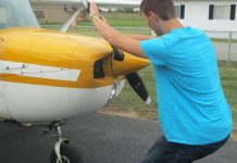 The alternative to bending down as the propeller is pulled through the compression stroke is to keep the back straight and bend the knees slightly, stepping away in a crouch. [Credit: LeRoy Cook]