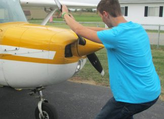 The alternative to bending down as the propeller is pulled through the compression stroke is to keep the back straight and bend the knees slightly, stepping away in a crouch. [Credit: LeRoy Cook]