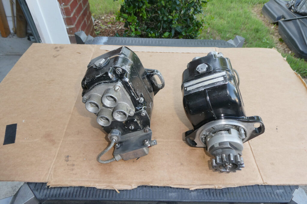 Both magnetos complete. Flight unit on the right is newly painted, and impulse coupling assembly visible. The “ground” unit was left scruffy looking; plug wire towers with P-lead and filter visible.