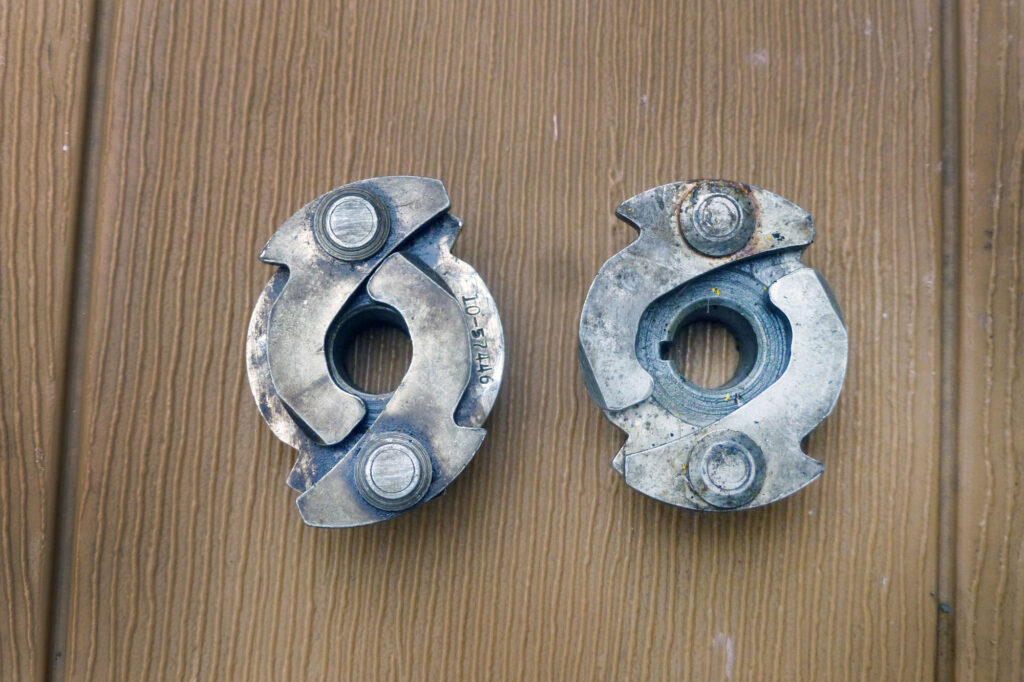 The underside of the impulse coupling showing the cams/flyweights. The one on the left has the weights pulled in such that the other end engages the studs for starting, whereas the one on the right depicts the flyweights at speed so that they spin without contact. Rotation is to the right as viewed here.