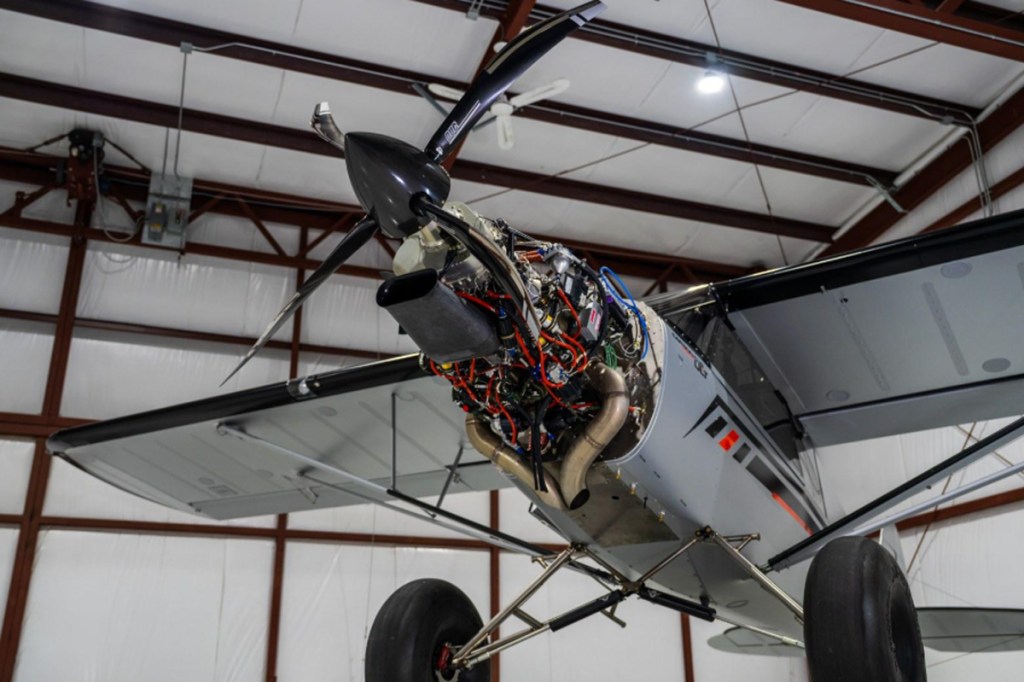 The story up front: with the cowling off, the TurboTech TP-R90 regenerative turboprop is exposed at the nose. [Credit: CubCrafters]