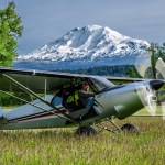 Backcountry manners intact: the ULT sits on a grass strip with the turbine spun up, built on the STOL-capable Carbon Cub UL airframe. [Credit: CubCrafters]