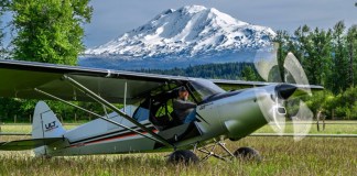 Backcountry manners intact: the ULT sits on a grass strip with the turbine spun up, built on the STOL-capable Carbon Cub UL airframe. [Credit: CubCrafters]