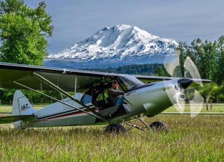 Backcountry manners intact: the ULT sits on a grass strip with the turbine spun up, built on the STOL-capable Carbon Cub UL airframe. [Credit: CubCrafters]