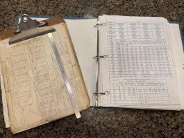 My 36 year old clipboard from when I started at Boeing. Engineering ruler and fastener/fastener hole cheat sheets. [Credit: Andrew Robinson]
