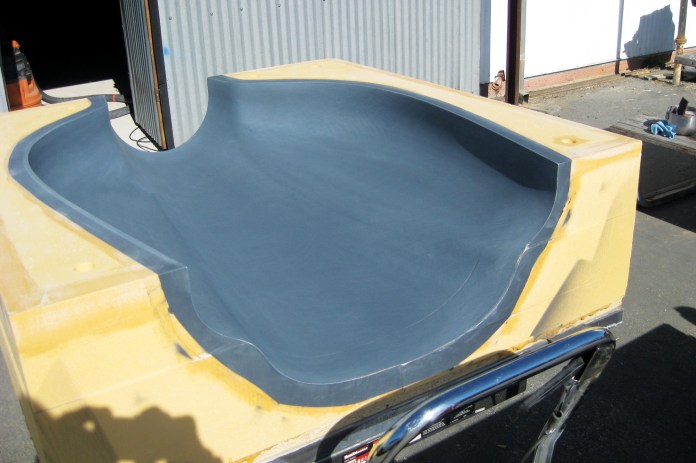 Top cowl mold being sanded smooth after being sprayed with Duratec.