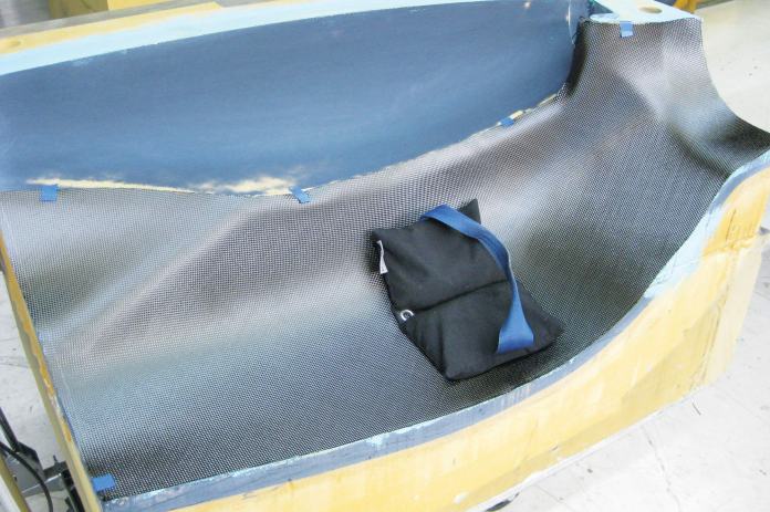 Checking the fit of the carbon cloth template before layup.