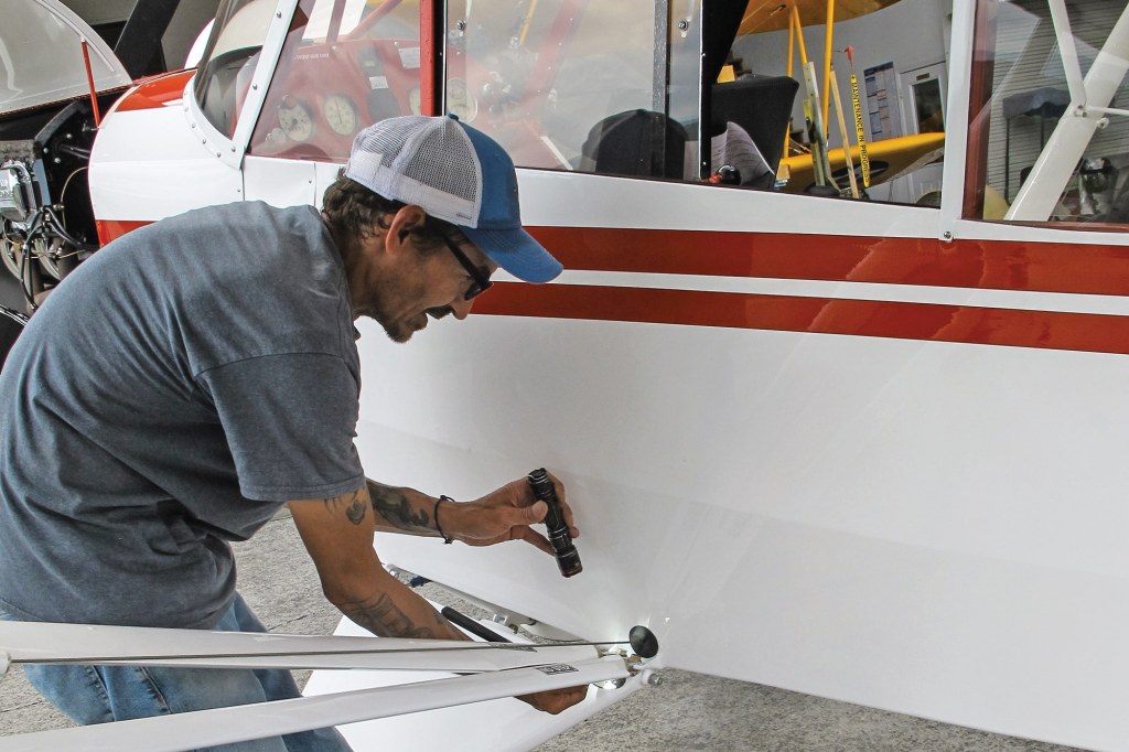 Maintenance technician William Vergonet conducts an inspection on a Cub. [Credit: Lisa Turner]