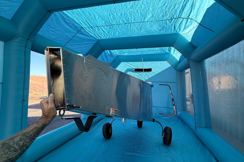 The airframe under cover in a portable inflatable shelter. [Credit: Carson Stilson]