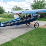 R.T. Searfoss shows off his magnificent workmanship in the Pietenpol Air Camper he built over the span of 12 years. There is much to love in classic tube and fabric aircraft which harken back to an earlier time of aircraft construction. Masterful craftsmanship is everywhere you look in R.T.’s work. [Credit: Bill Wilson]