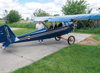 R.T. Searfoss shows off his magnificent workmanship in the Pietenpol Air Camper he built over the span of 12 years. There is much to love in classic tube and fabric aircraft which harken back to an earlier time of aircraft construction. Masterful craftsmanship is everywhere you look in R.T.’s work. [Credit: Bill Wilson]