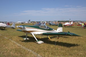 Green and white Van's RV-14 parked on grass at Sun 'n Fun